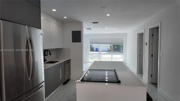 a kitchen with stainless steel appliances a refrigerator and a sink