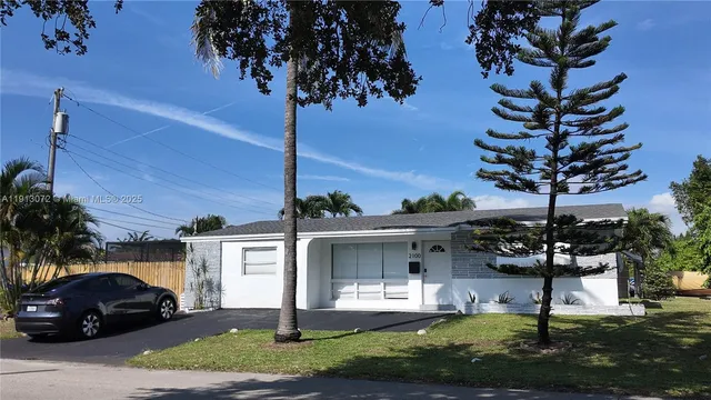 a view of a house with backyard porch and sitting area