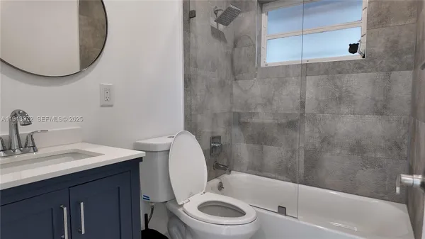a bathroom with a sink a toilet and a tub
