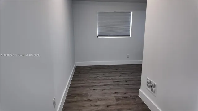 a kitchen with refrigerator and cabinets