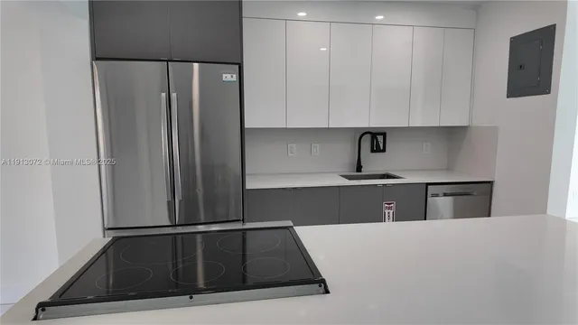 a kitchen with a refrigerator and cabinets