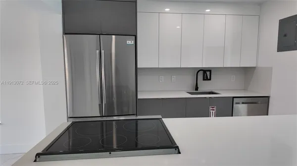 a kitchen with a refrigerator and cabinets