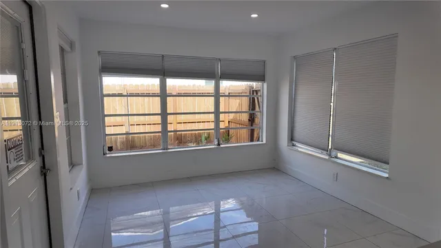 a kitchen with refrigerator and cabinets