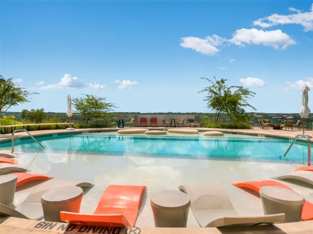 a view of a lake with couches chairs