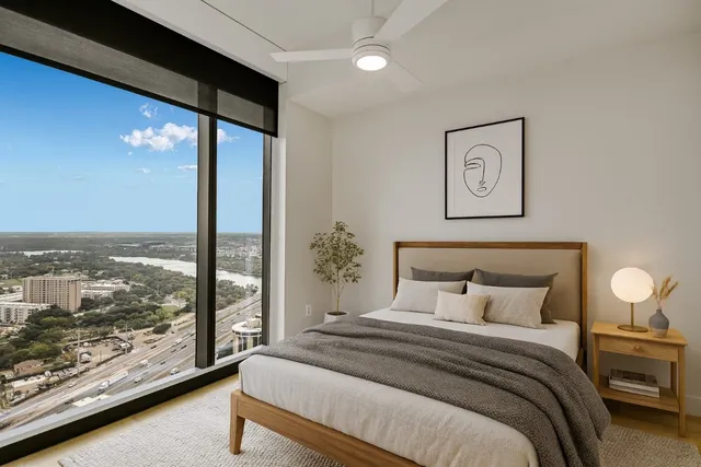 a bedroom with a large bed and a large window