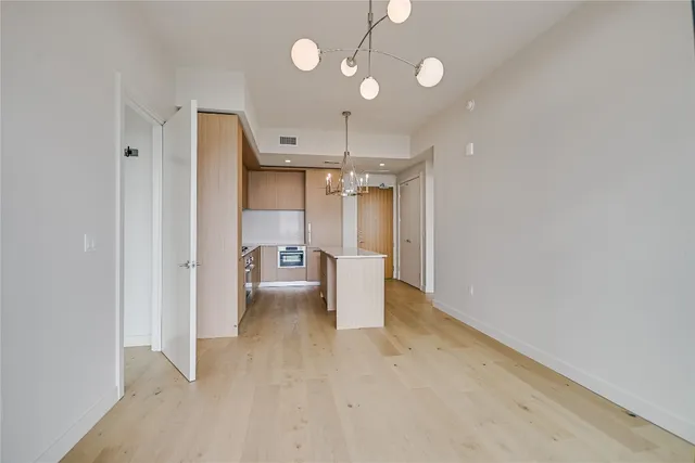 a view of a kitchen with a refrigerator and microwave