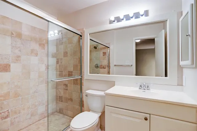 a bathroom with a sink toilet and shower