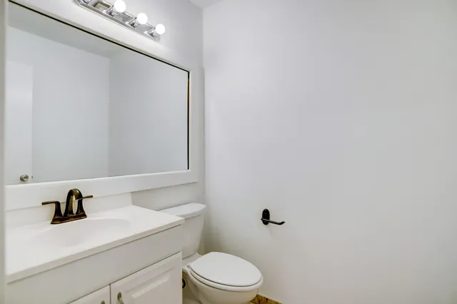 a bathroom with a sink a toilet and mirror