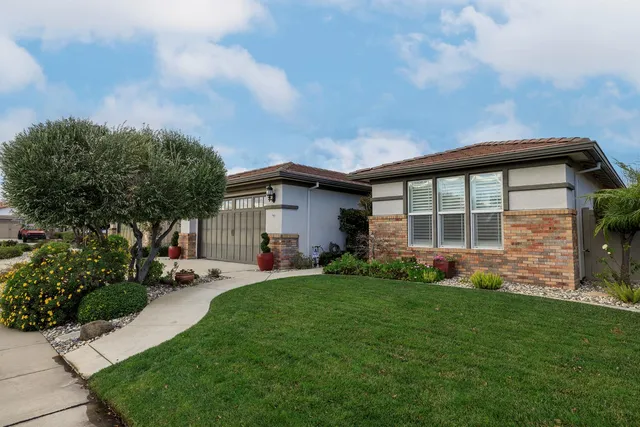 a view of a house with a yard and sitting area