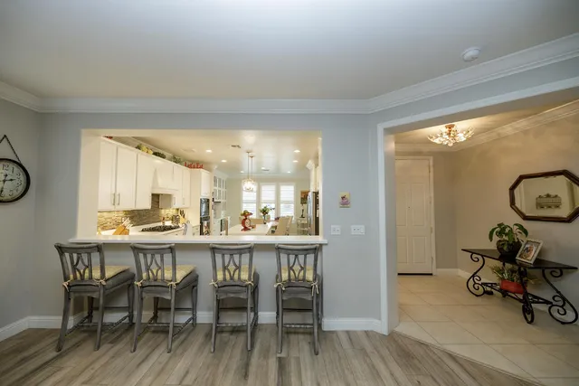 a kitchen with stainless steel appliances a refrigerator sink and microwave