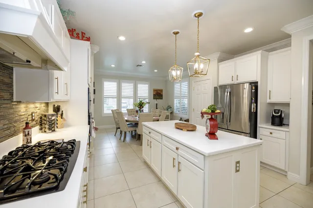 a kitchen with white cabinets appliances and sink
