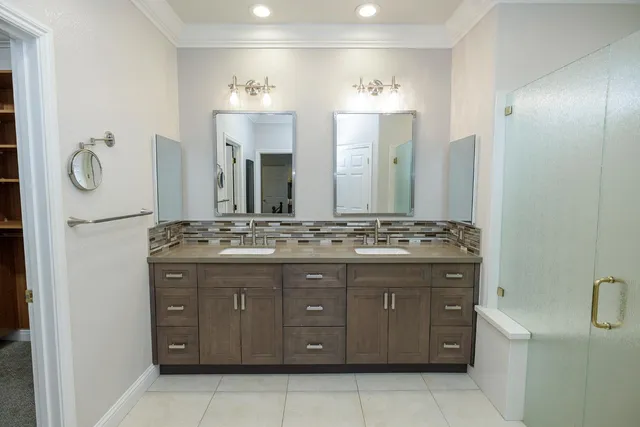 a bathroom with a shower sink and mirror