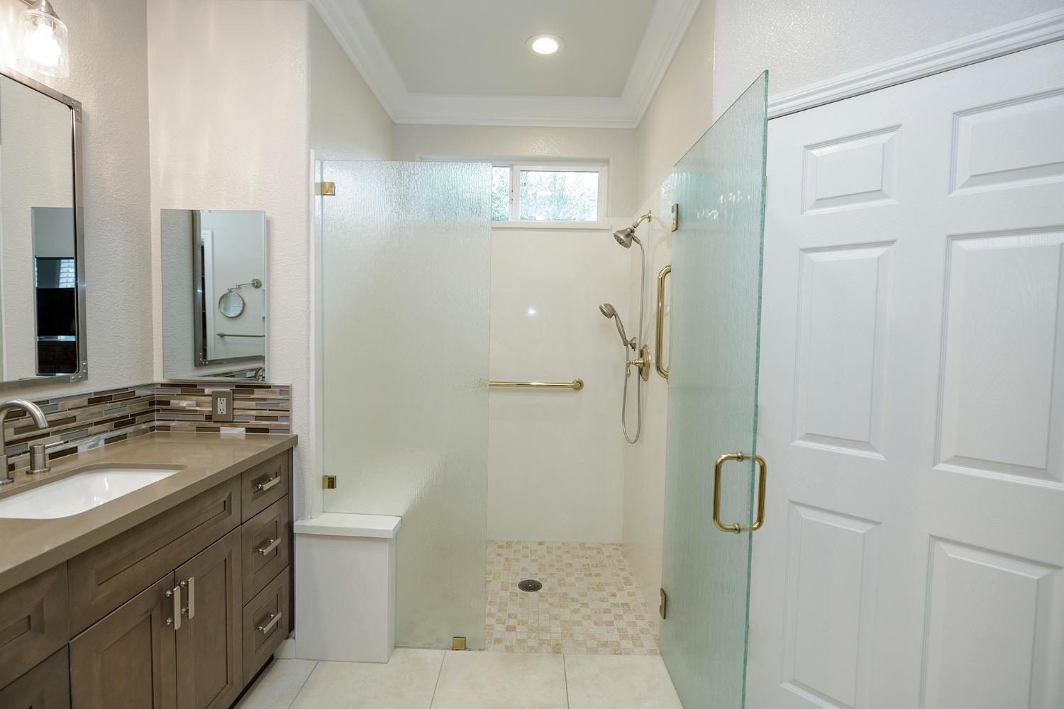 1771 Fox Trot Way Manteca, CA 95336 - Photo 32 of 54 a bathroom with a shower sink and mirror