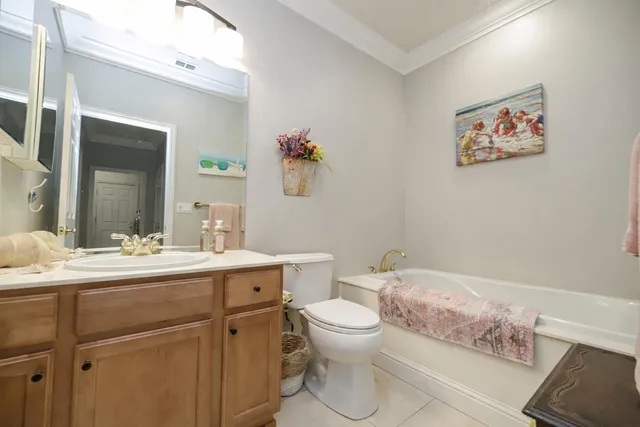 a bathroom with a sink mirror vanity and toilet
