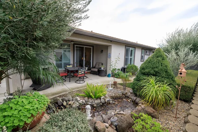 a view of a backyard with sitting area and furniture
