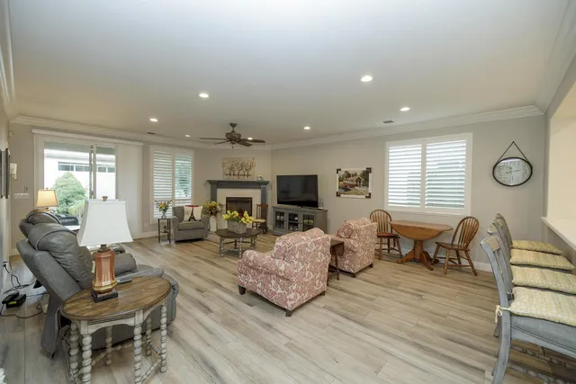 a living room with furniture flat screen tv and a fireplace