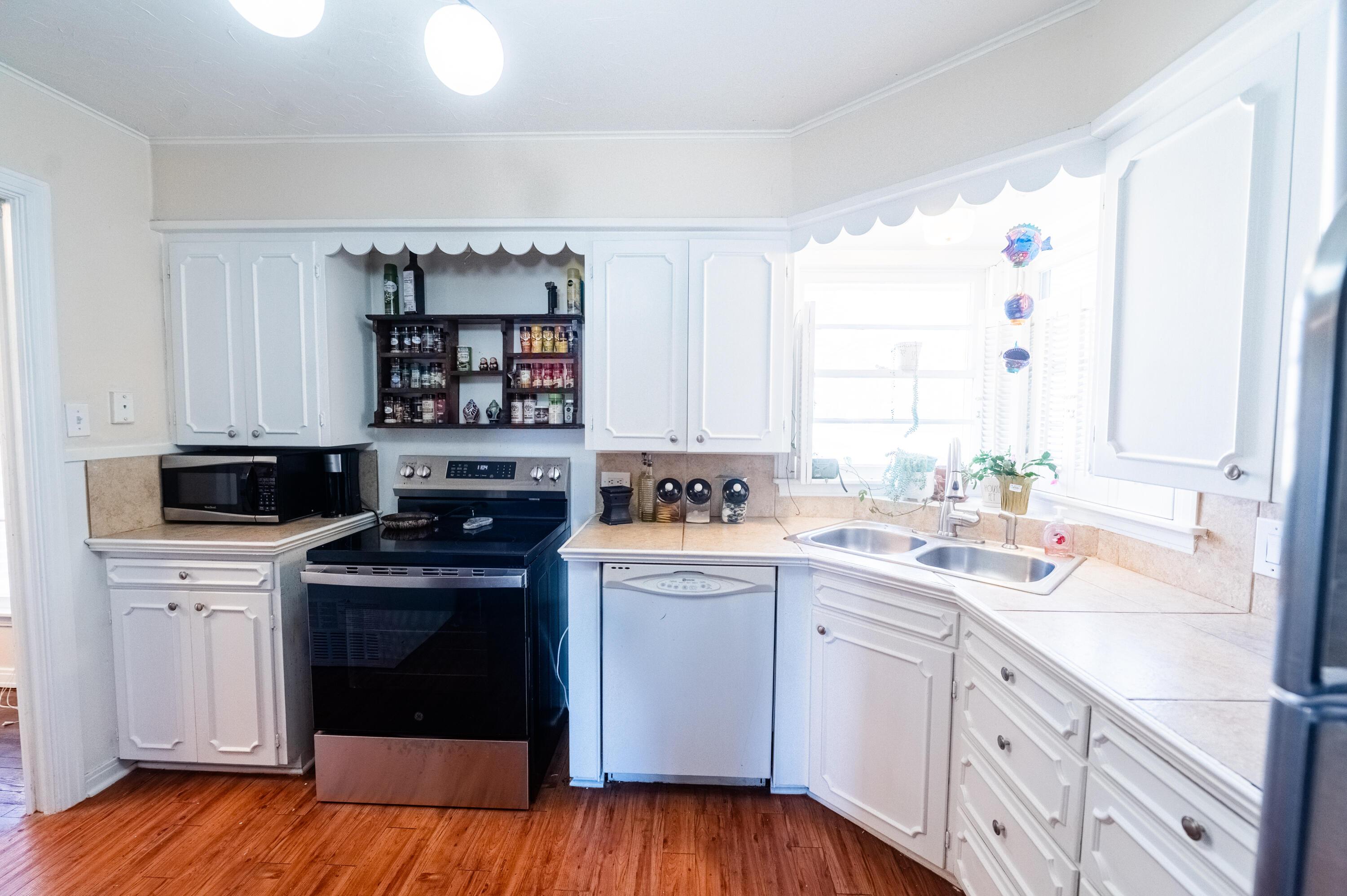 520 East 12th Street Littlefield, TX 79339 - Photo 5 of 17 a kitchen with a stove sink and cabinets