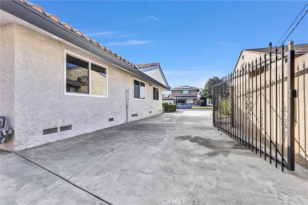a view of a house with a garage and potted plants