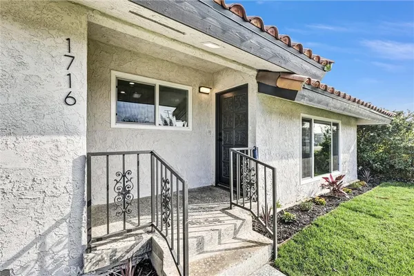 a view of house with wooden floor and outdoor seating
