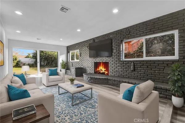a living room with furniture fireplace and a flat screen tv