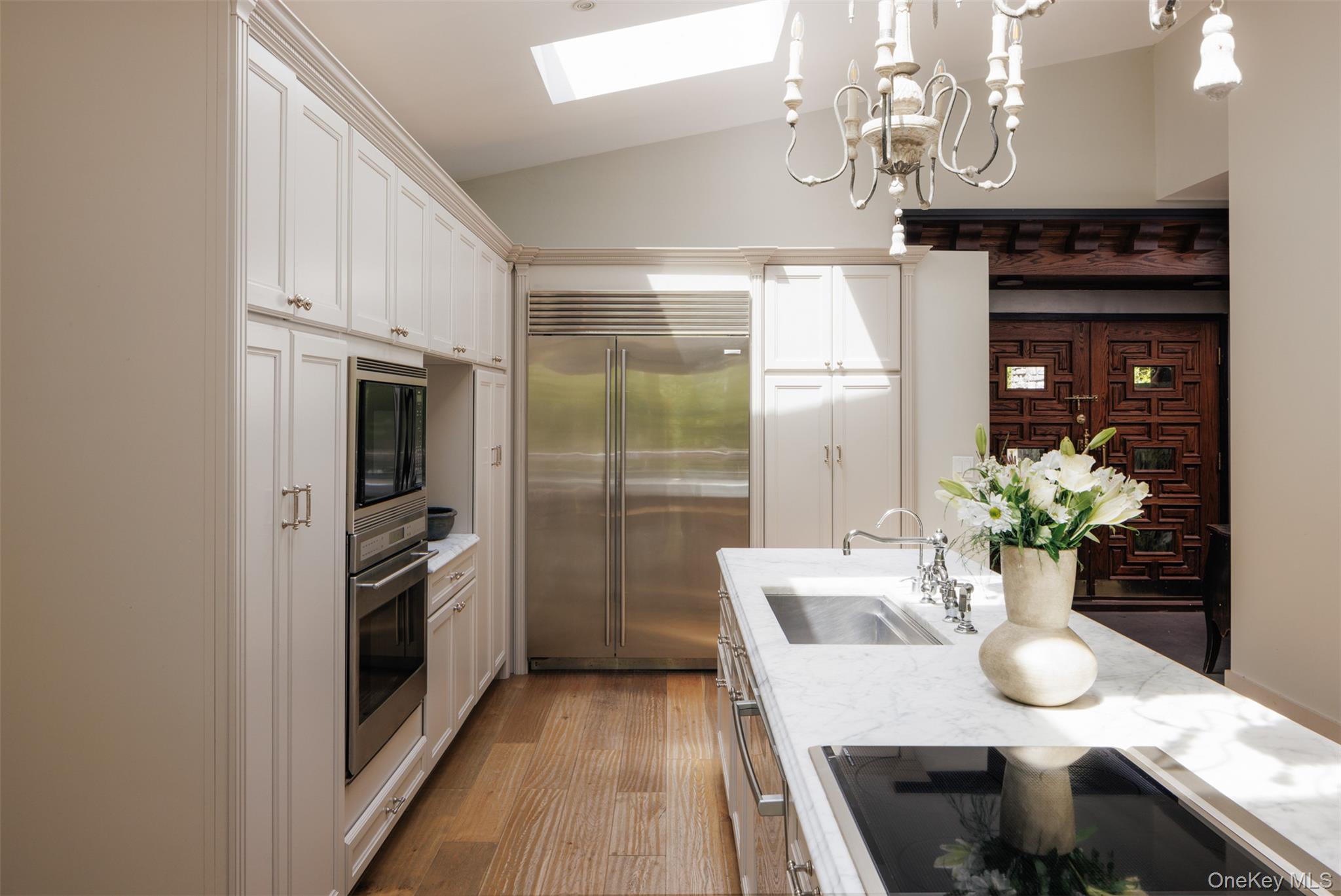 320 Long Hill Road Hopewell Junction, NY 12533 - Photo 5 of 42 a kitchen with stainless steel appliances kitchen island granite countertop a refrigerator a stove a microwave oven a dining table and chairs with wooden floor