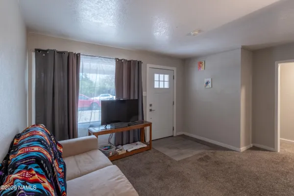 a living room with furniture and a flat screen tv