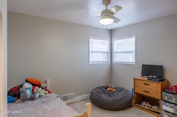 a bedroom with furniture and a window