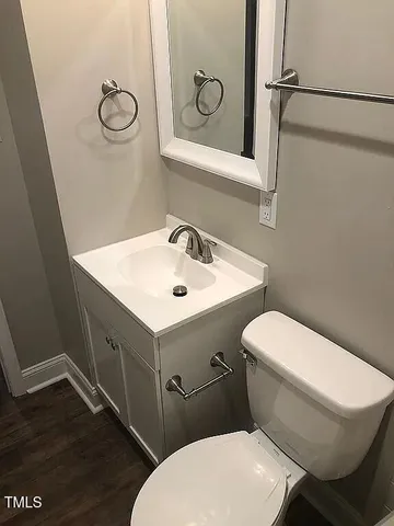 a white toilet sitting next to a bathroom sink