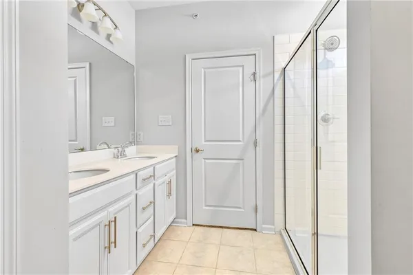 a bathroom with a double vanity sink and mirror