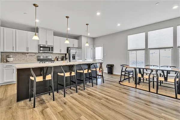 a large kitchen with a table and chairs