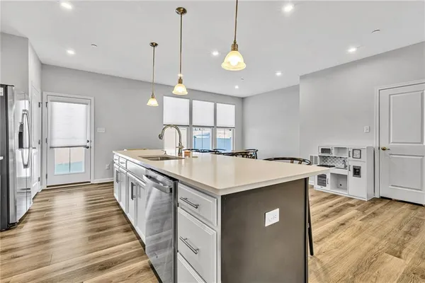 a kitchen with counter top space a sink appliances and cabinets