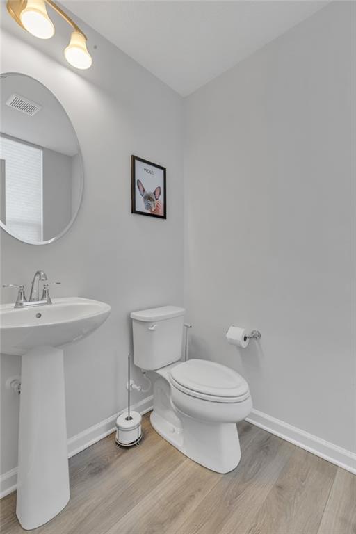 119 Rivulet Place Zelienople, PA 16063 - Photo 7 of 25 a bathroom with a toilet a sink and mirror