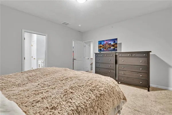 a bedroom with a bed and a mirror