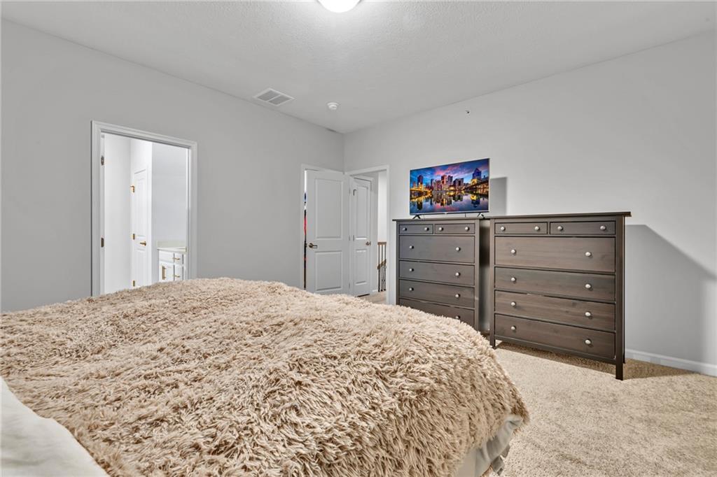119 Rivulet Place Zelienople, PA 16063 - Photo 10 of 25 a bedroom with a bed and a mirror