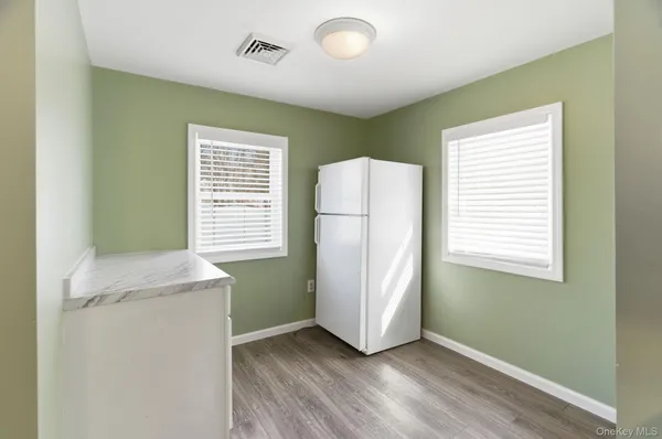 a kitchen with a sink cabinets and wooden floor