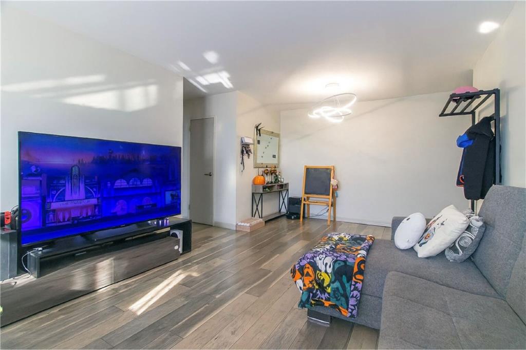 2652 Cropsey Avenue, Unit 9H Brooklyn, NY 11214 - Photo 11 of 23 a living room with furniture and stairs