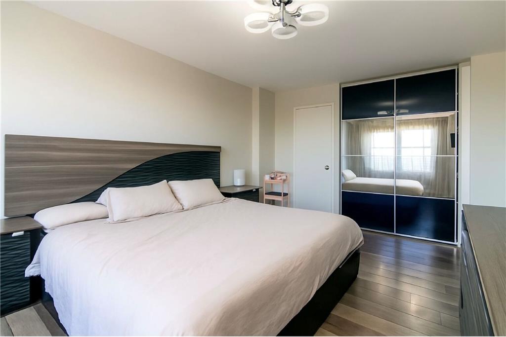 2652 Cropsey Avenue, Unit 9H Brooklyn, NY 11214 - Photo 3 of 23 a bedroom with a large bed and a window