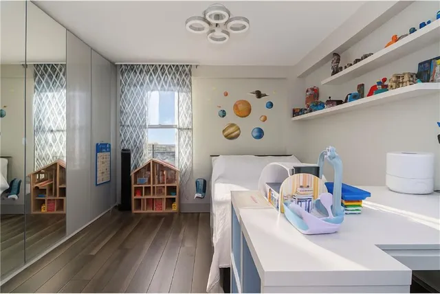 a bedroom with furniture and a wooden floor