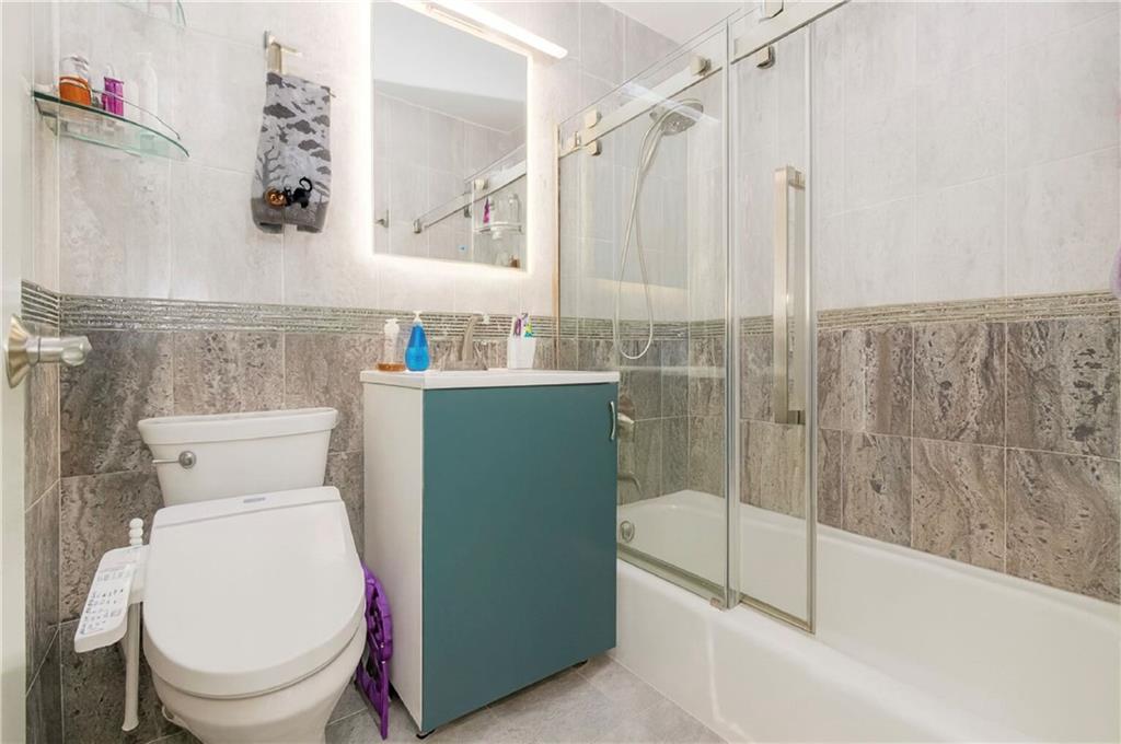 2652 Cropsey Avenue, Unit 9H Brooklyn, NY 11214 - Photo 6 of 23 a bathroom with a toilet and a sink