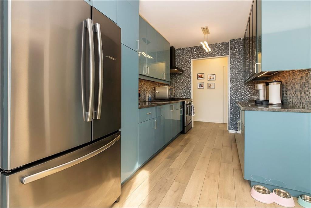 2652 Cropsey Avenue, Unit 9H Brooklyn, NY 11214 - Photo 7 of 23 a kitchen with stainless steel appliances a refrigerator and a stove