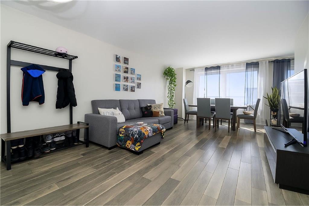 2652 Cropsey Avenue, Unit 9H Brooklyn, NY 11214 - Photo 9 of 23 a living room with furniture and wooden floor