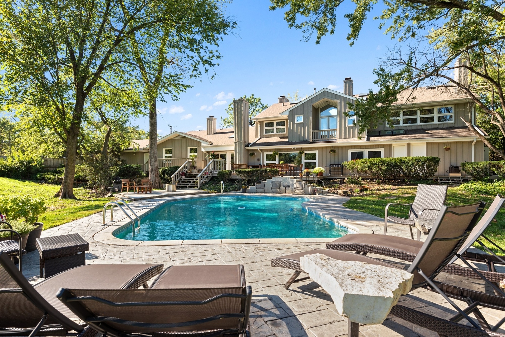 470 Voltz Road Northbrook, IL 60062 - Photo 50 of 58 a view of a patio with couches table and chairs with potted plants and large trees