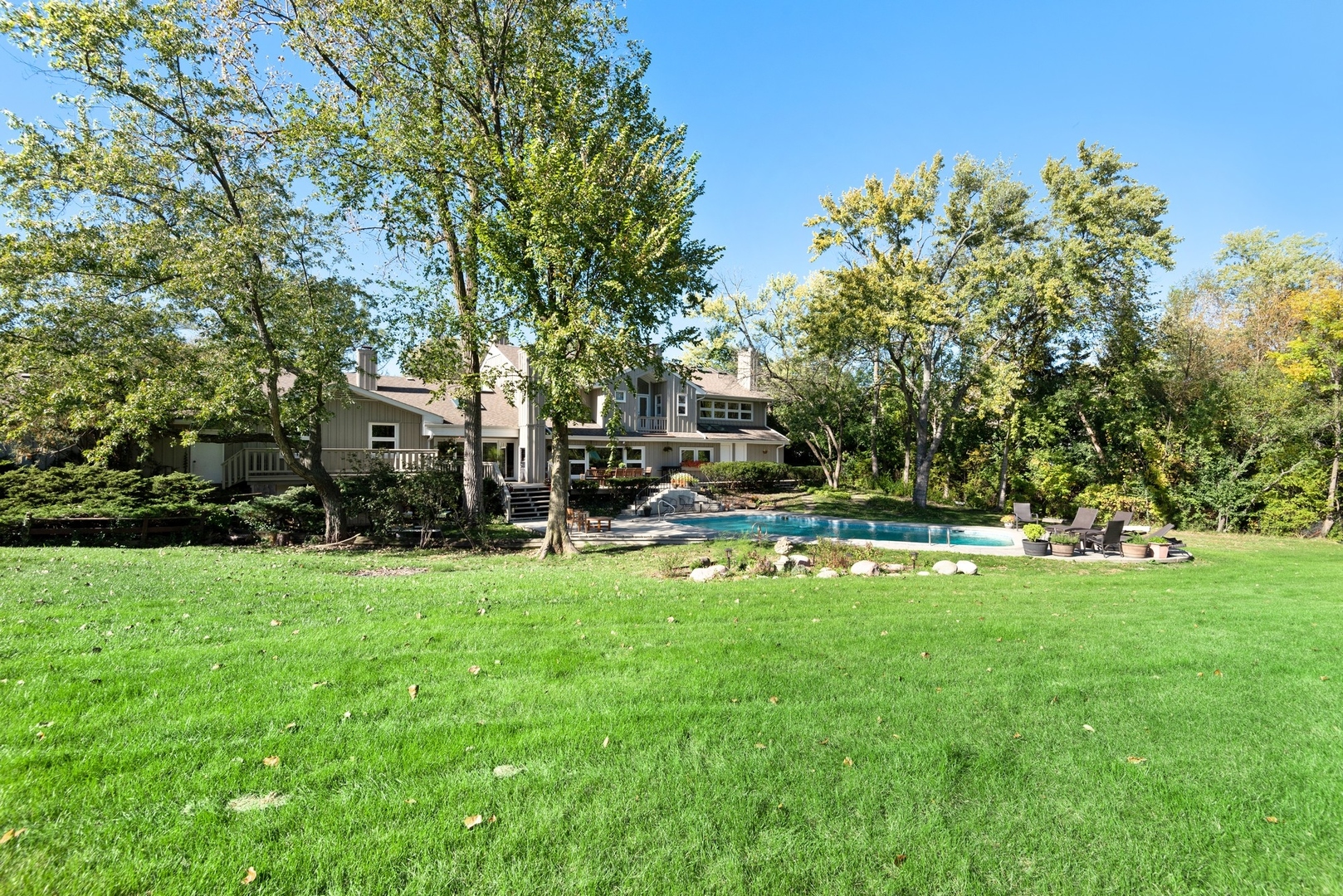 470 Voltz Road Northbrook, IL 60062 - Photo 54 of 58 a view of a swimming pool with lawn chairs and a big yard