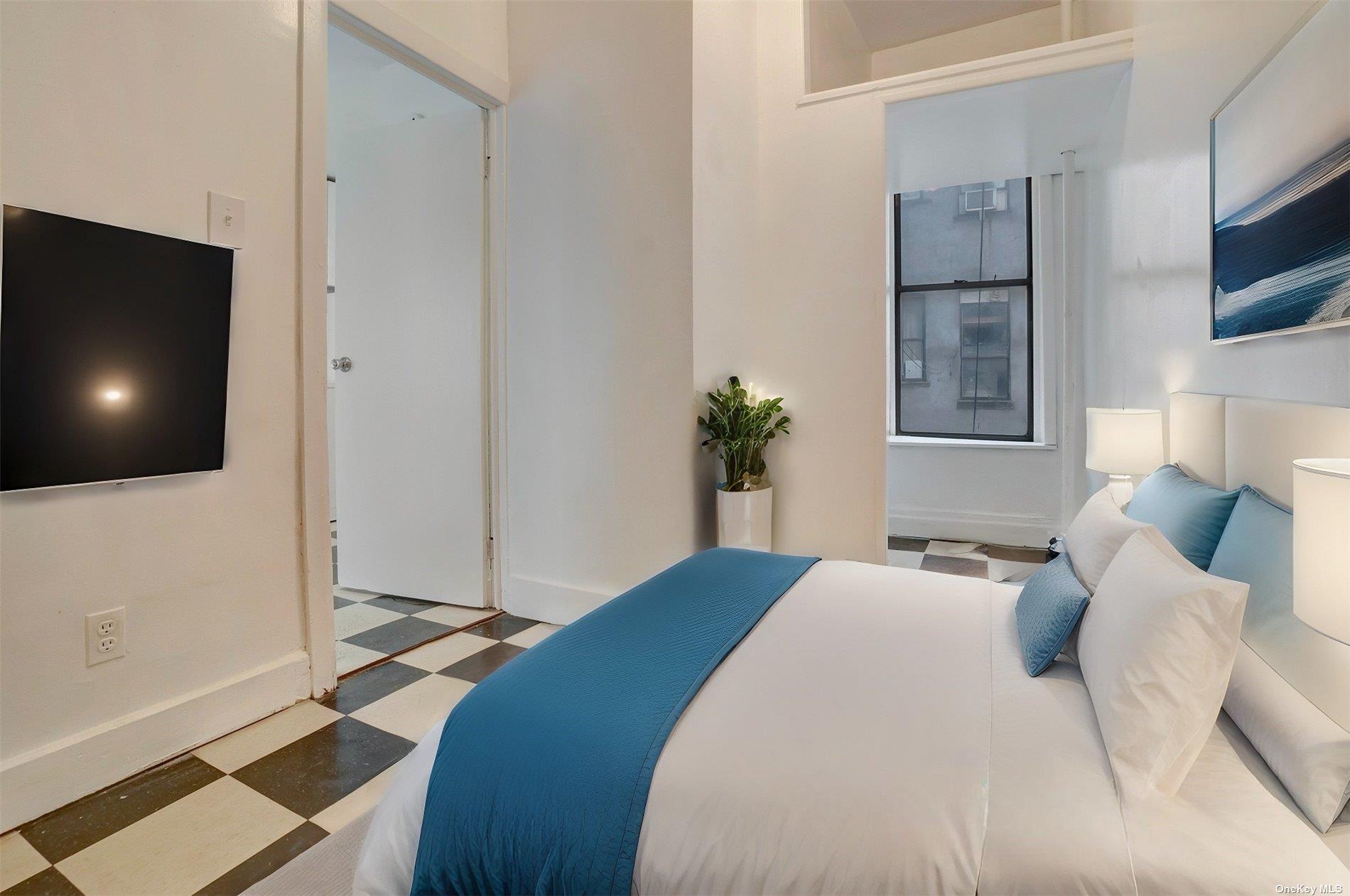 76 Richardson Street, Unit 7 Brooklyn, NY 11211 - Photo 5 of 9 a bedroom with a bed and a flat screen tv