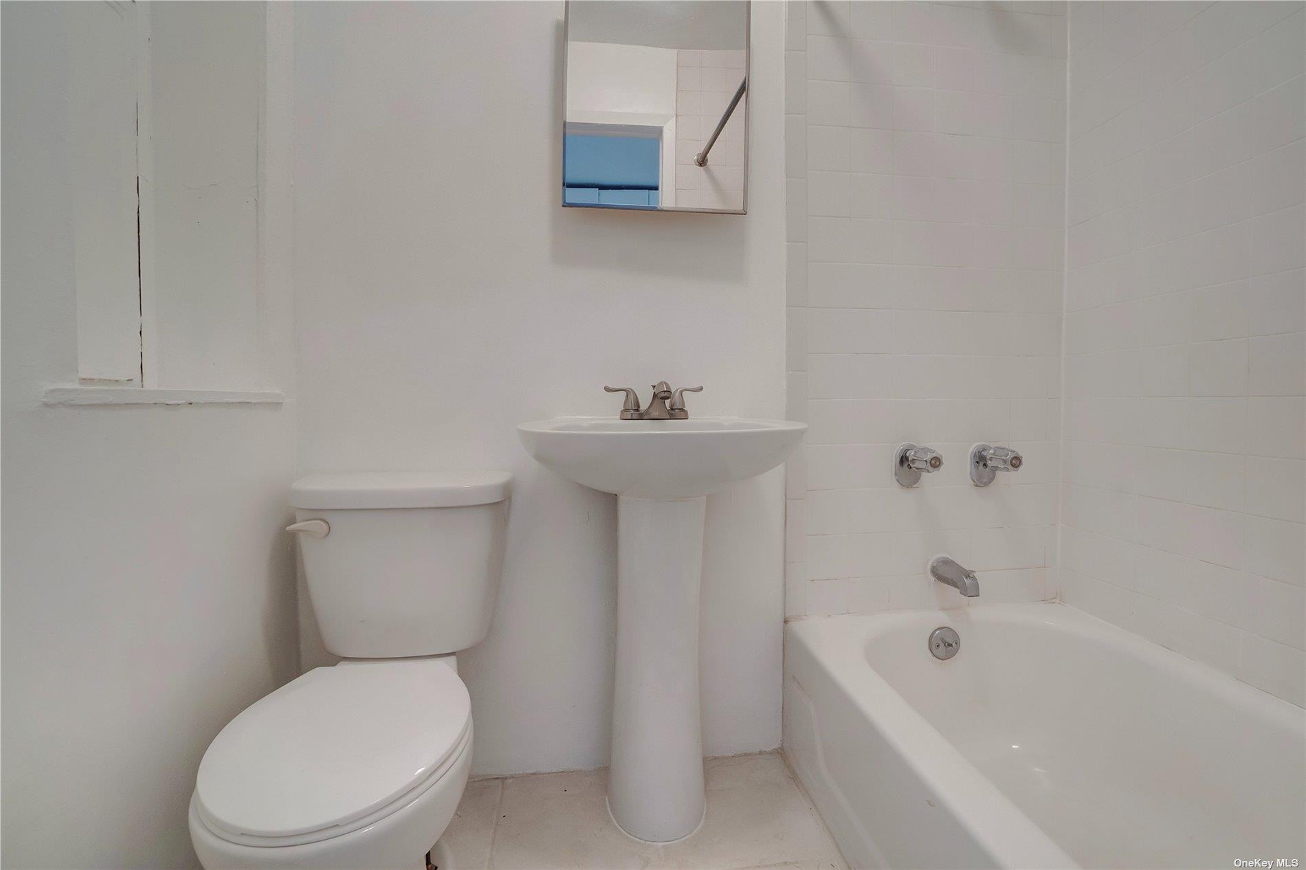 76 Richardson Street, Unit 7 Brooklyn, NY 11211 - Photo 8 of 9 a white toilet sitting next to a bath tub