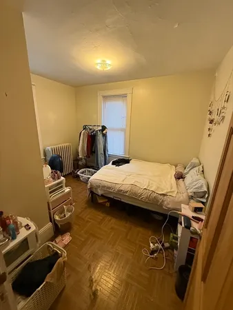 a bedroom with a bed and a mirror