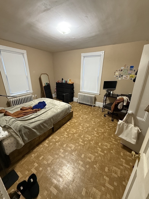 10 Eldora Street Boston, MA 02120 - Photo 19 of 26 a bedroom with a bed and a flat tv screen on the dresser