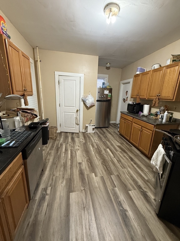 10 Eldora Street Boston, MA 02120 - Photo 7 of 26 a view of kitchen with stove microwave and cabinets