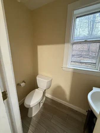 a white toilet sitting next to a bathroom sink