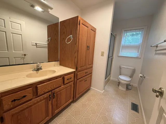 a white toilet sitting next to a bathroom